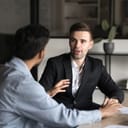 two businessmen discussing job strategy and conducting negotiations in an office setting