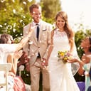 A married couple walking down the isle at an outdoor wedding ceremony