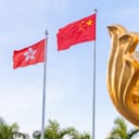 Golden Bauhinia Square in Hong Kong with flags and the Forever Blooming Bauhinia Sculpture, a symbol of the 1997 Handover from Britain to China