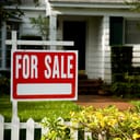For sale sign outside a family house