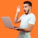 Panicked man looking at laptop against an orange background