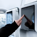Details of an airplane interior with the touch screen monitor for in-flight entertainment.

