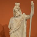 Ancient statue against an orangish background