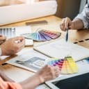 People at a table discussing color palettes for interior decoration