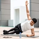 A young man doing exercises on an exercise mat