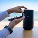 Person pairing a smartphone with a Bluetooth speaker