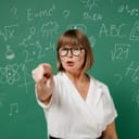 A female teacher pointing a finger at someone in front of a board
