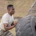 close-up of a soldier in boot camp working out with a big tire