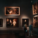 Room in a museum with visitors admiring various paintings