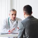 Senior doctor consults young patient