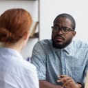 A man looking at a woman in a distrusting fashion