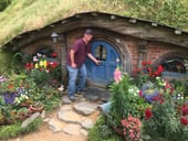 Man about to enter a replica of a Hobbit house