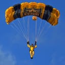 Parachutist coming down from the sky