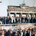 People stand on top of the Berlin Wall in 1989.