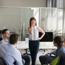 A female employee feeling embarrassed after making a mistake in front of colleagues.