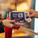 Closeup of someone buying cinema tickets.