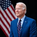 Joe Biden standing in front of a US flag