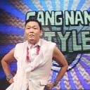 PSY stands in front of a "Gangnam Style" logo

