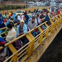 Hundreds of Venezuelans wait in line at the Customs Office in Ecuador.