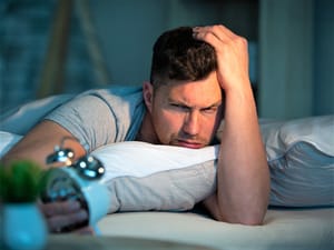 Exhausted woman laying face down on a couch