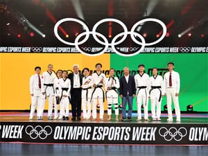 Second runner-up Wu Jingyu of Team China, winner Nigel Tan of Team Singapore and first runner-up Natalie Tor of Team Singapore celebrate with their respective trophies for the Virtual Taekwondo finals on day four of the Olympic Esports Week at Suntec Singapore Convention & Exhibition Centre