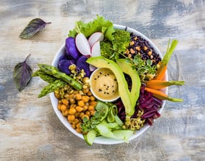Fresh vegetables, fruits and seeds on black table