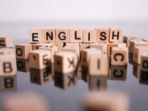 the word 'English' spelled out with wooden letter cubes