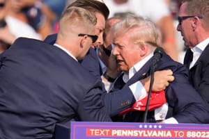 Republican presidential candidate former President Donald Trump is helped off the stage by U.S. Secret Service agents at a campaign event in Butler, Pa., on Saturday, July 13, 2024.