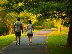 Two people walking in a park