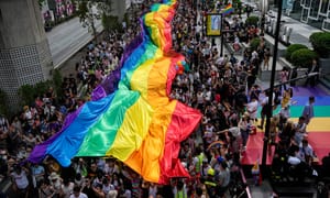Participants hold a rainbow flag during the Pride Parade in Bangkok, Thailand, Saturday, June 1, 2024.