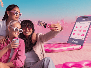 three girls taking a selfie with a new Barbie phone