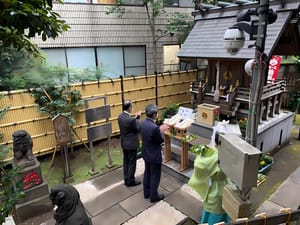 two men praying at the Meteorological Shrine, Kisho Jinja