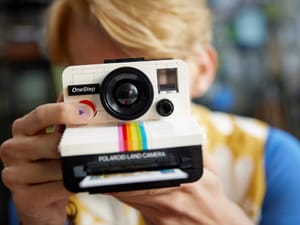 A man holding a LEGO Polaroid