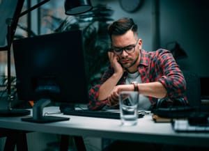 an empty modern office with desktops turned off on wooden desks