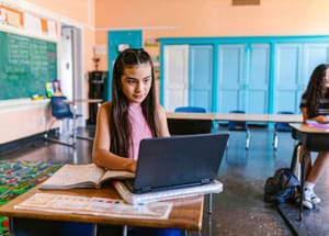 Students Using Computer In Classroom Cheating Thousands of UK Students Caught Using AI to Cheat | Engoo 每日新聞