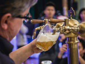 Man pulling pint of beer.
