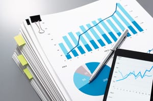A stack of papers showing various graphs and charts.

