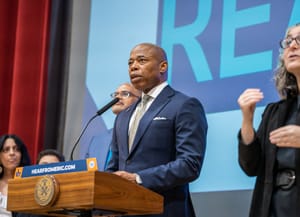 New York mayor Eric Adams addressing the audience from a platform