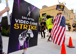 A picket at a kick-off picket line for the SAG-AFTRA video game strike at Warner Bros. Games headquarters on Thursday, Aug. 1, 2024, in Burbank, Calif.