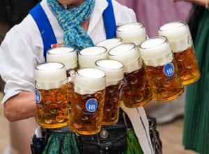 Waitresses carry beer mugs in the Hofbraeuhaus beer tent on day one of the 189th 'Oktoberfest' beer festival in Munich, Germany, Saturday, Sept. 21, 2024.