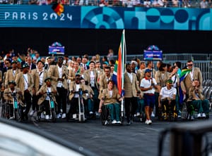 Flagbearers Mpumelelo Mhlongo of South Africa and Kat Swanepoel of South Africa lead their contingent during the Opening Ceremony for the 2024 Paralympics, Wednesday, Aug. 28, 2024, in Paris, France.