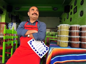 Mexican restaurant chef and owner waiting for clients outside his restaurant in Puebla, Mexico.