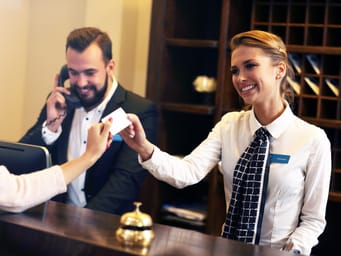 Picture of guests getting key card in hotel at reception