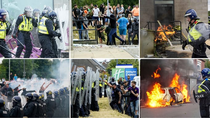 A protester uses a fire extinguisher on police officers as trouble flares during an anti-immigration protest outside the Holiday Inn Express in Rotherham, England, Sunday Aug. 4, 2024. 