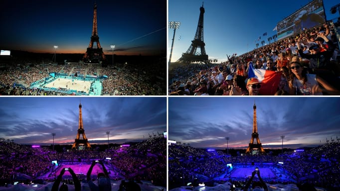 Spectators photograph a colorful sunset at Eiffel Tower Stadium prior to a beach volleyball match between The United States and Canada at the 2024 Summer Olympics, Saturday, July 27, 2024, in Paris, France.